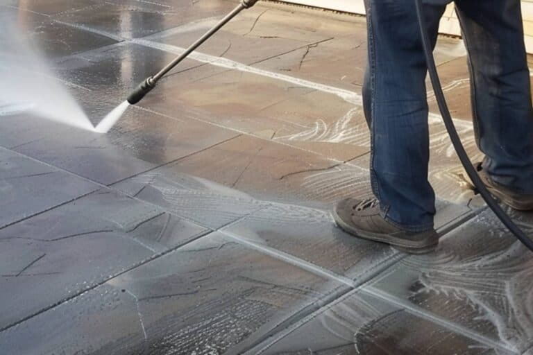 A Man Using Pressure Washer on Stamped Concrete